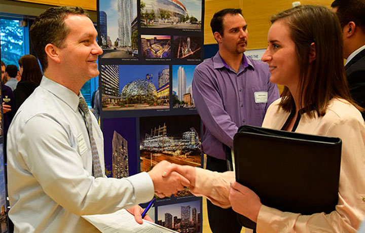 two people shaking hands at the career fair