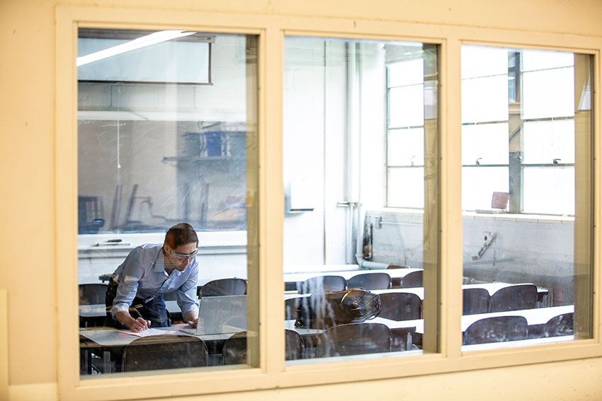 Julian Yamaura in a lab in front of a camera