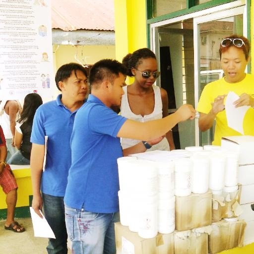 Judy Khalamwa helping collect water treatment packs