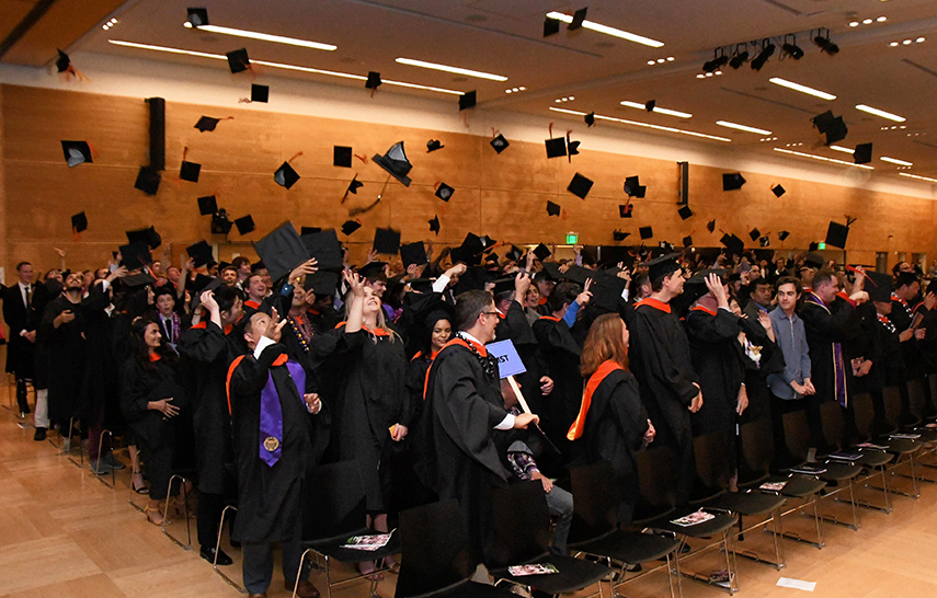 Graduates throwing their caps in the air