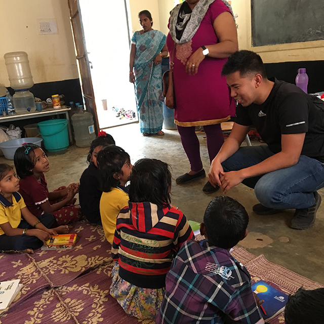 photo of Mark Galiza with school children