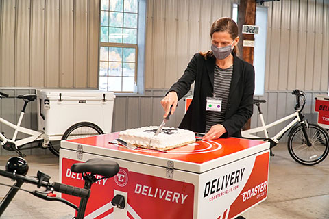 Anne Goodchild cutting a cake