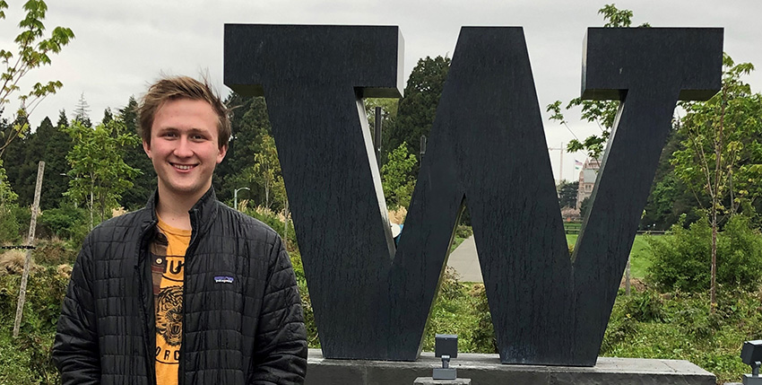 Adam Bogh standing in front of some greenery