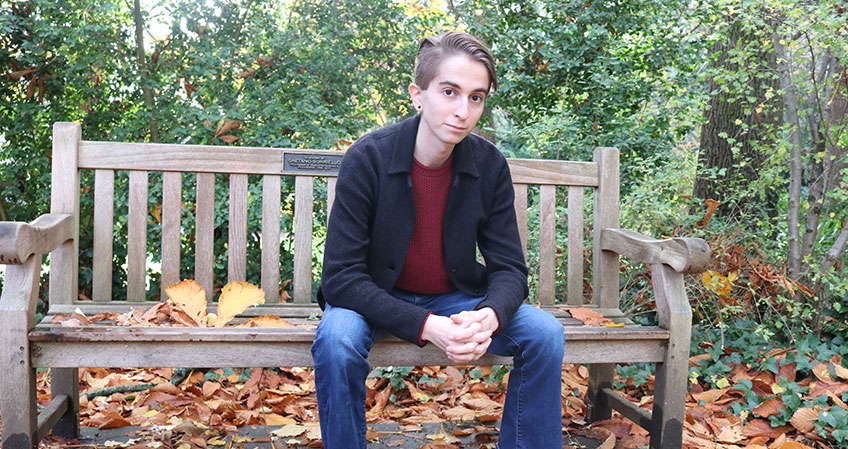 Adi Stein sitting on a bench