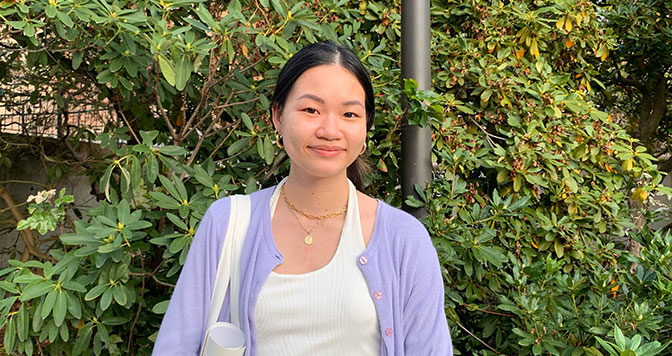 Nancy Le standing in front of some greenery