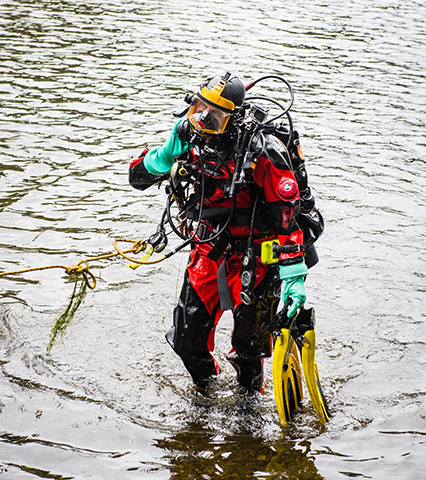 A scuba diver emerging out of the water