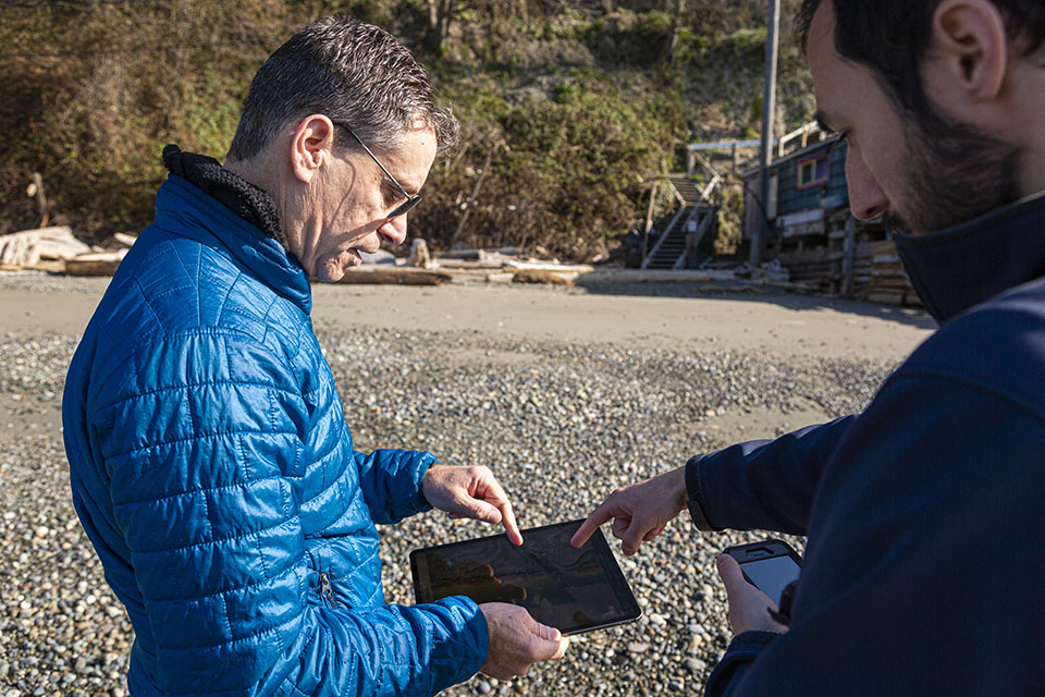 Researchers looking at a tablet together