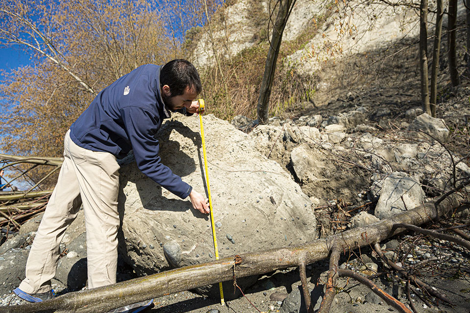 Researcher mesuring a block of glacial soil