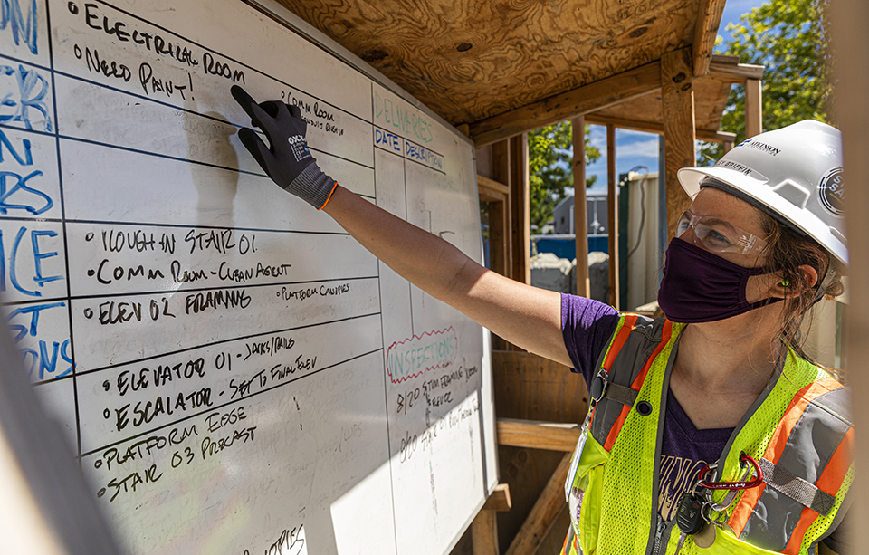 Student pointing at a white board