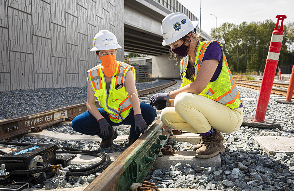 Two students working on a railroad track