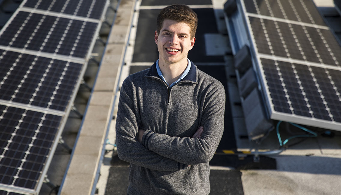 Alex Ratcliff standing on the rooftop of Maple Hall