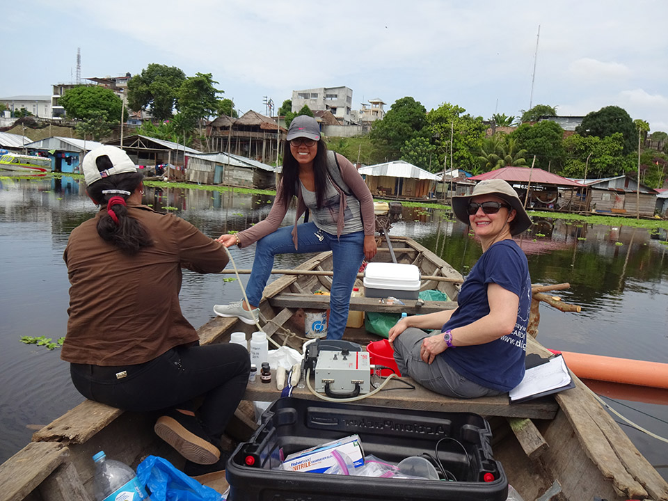 photo of Becca Neuman and two researchers on a boat