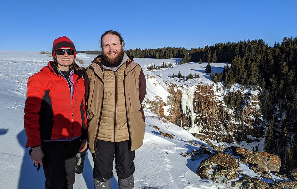 Two researchers standing in the snow