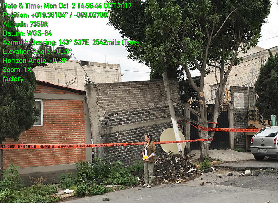 Menzer Pehlivan stands in front of a condemned building