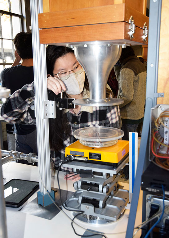 A student positions a pitot tube