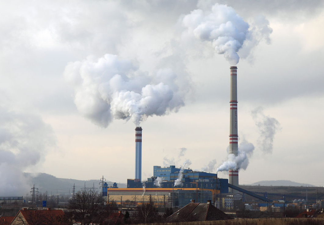 white smoke coming out of factory chimneys