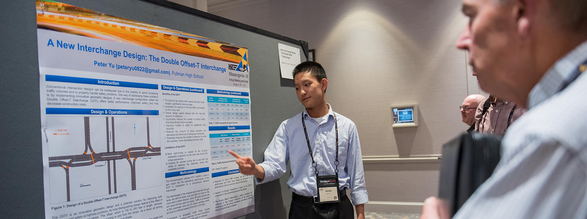Peter Yu pointing at an exhibition display