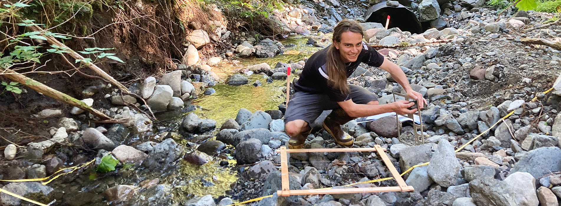 Matthew Bonner conducting research next to a river