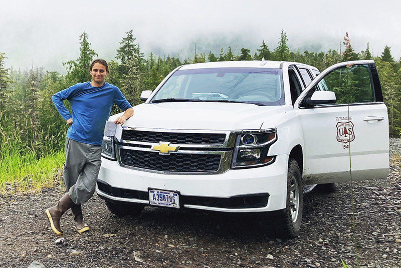 Matthew Bonner standing next to a U.S. Forest Service truck