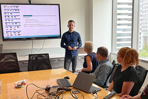 A student giving a presentation in front of a group of people