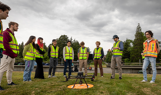 a group of people standing around a drone