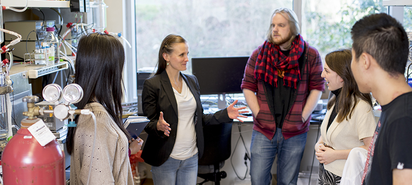 students and professor in lab