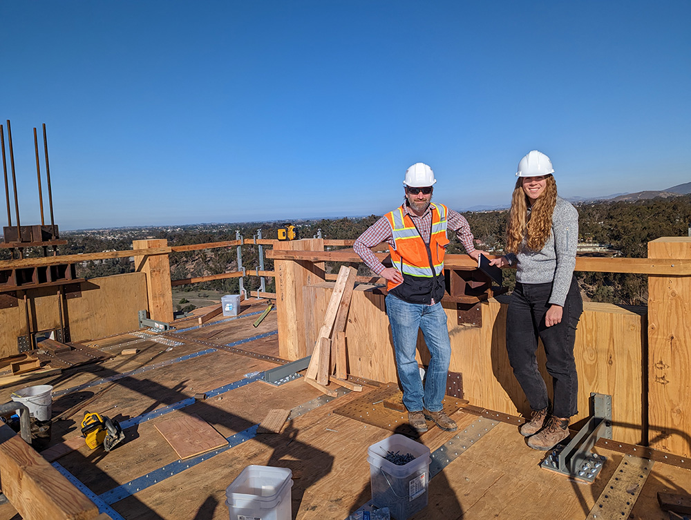 Professor Jeff Berman and Ph.D. student Sarah Wichman standing on top of a timber building