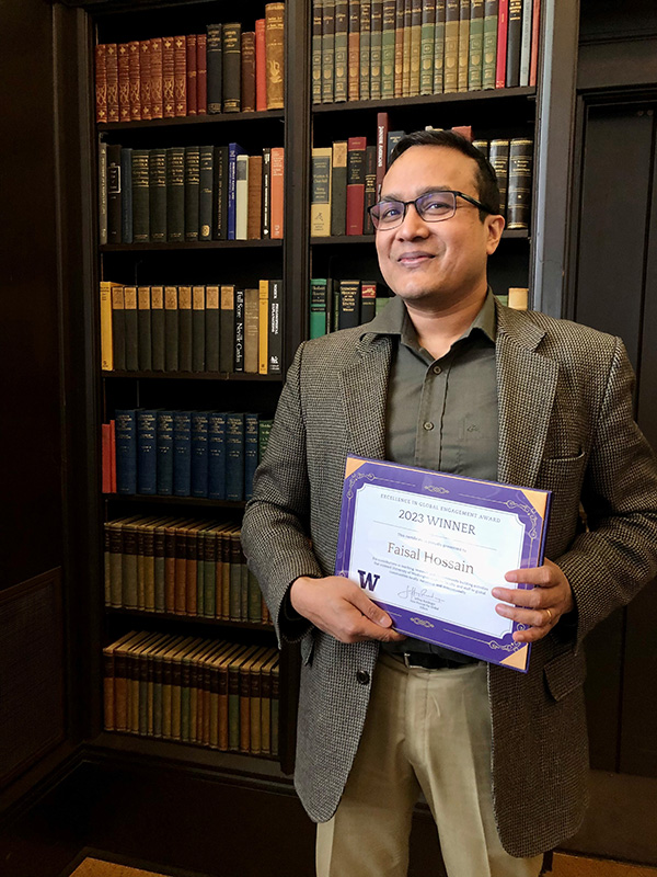 Faisal Hossain holding an award certificate