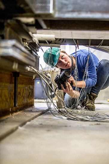 student with camera in structures lab