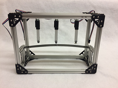 Feedback-controlled load frame for investigation of unstable equilibria of buckled structures