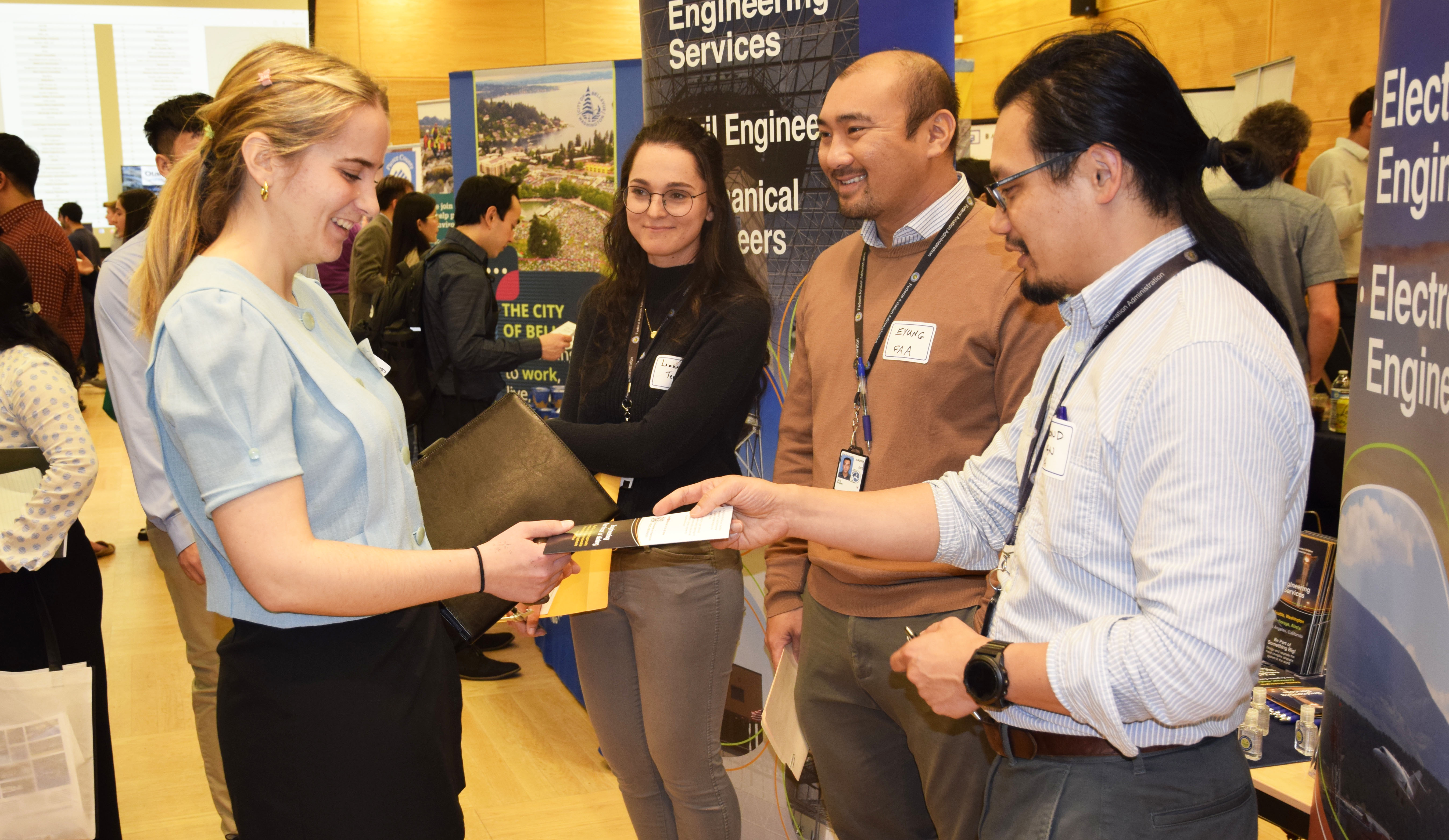 student receiving a flyer at the Career Fair