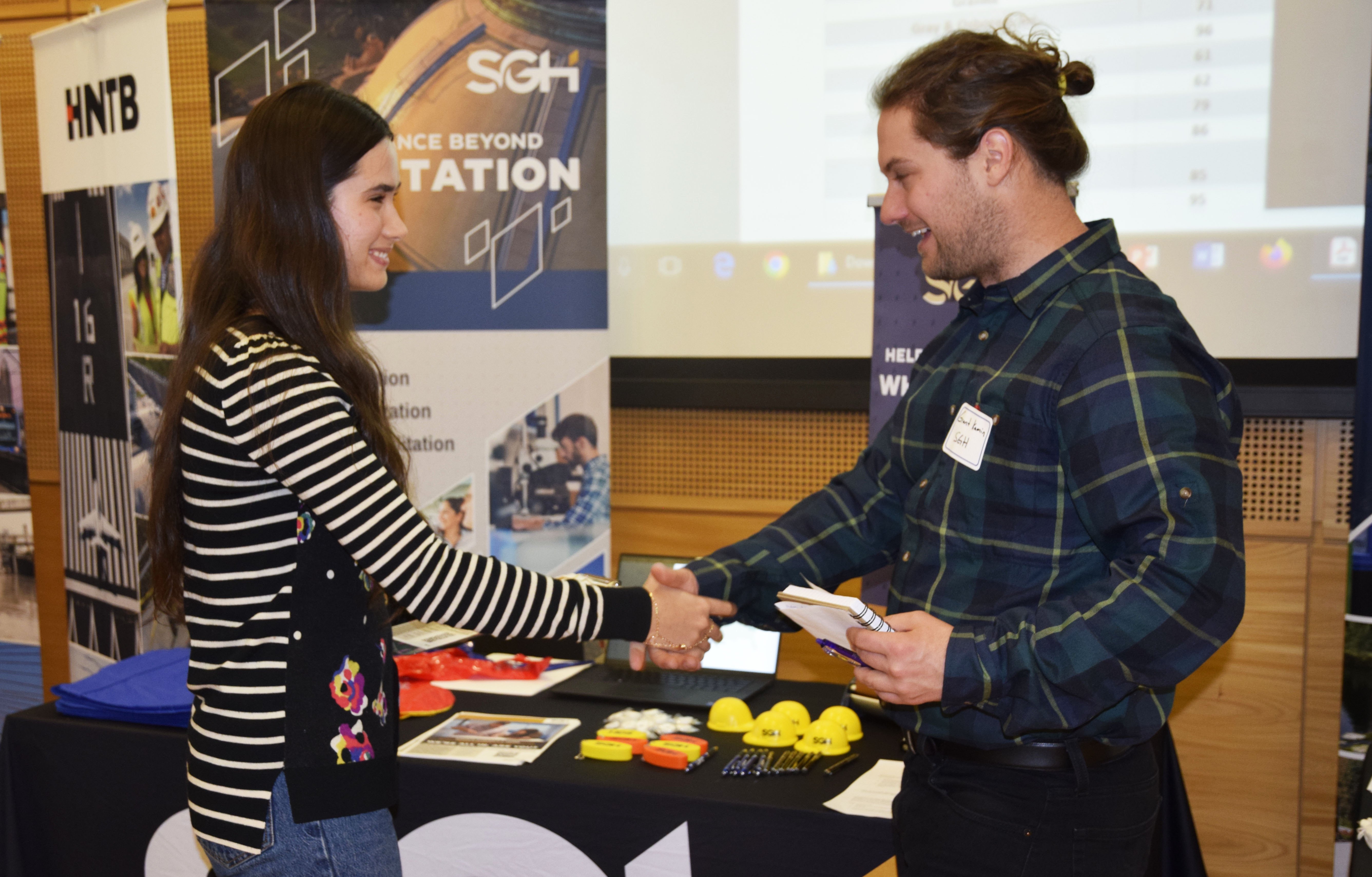 student shaking hands with an employer
