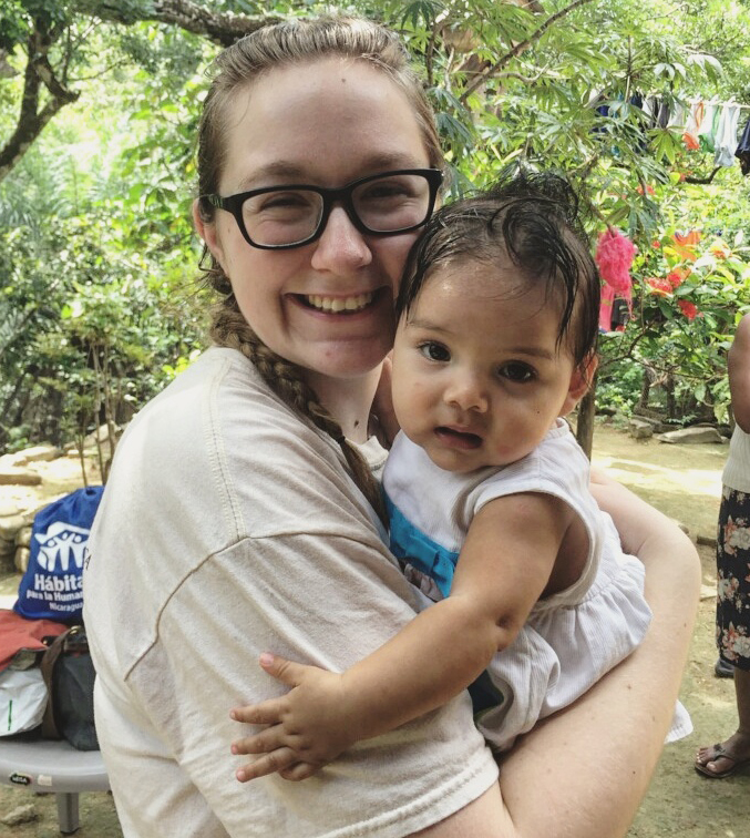 CEE sophomore and project lead MaKenzie Fockler holding child