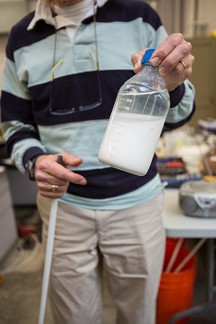 Mark Benjamin holds a bottle that contains patented particles