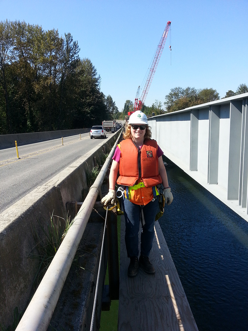 Alumna Amy Leland standing on the former Snohomish River bridge