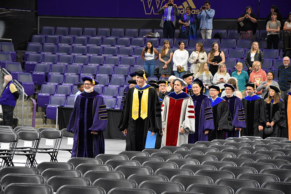 Faculty members in academic regalia entering the ceremony hall.
