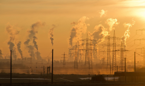 A picture of power lines at sunset. Everything is hazy. 