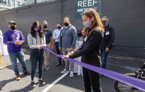 Professor Anne Goodchild cuts a ribbon at a ceremony