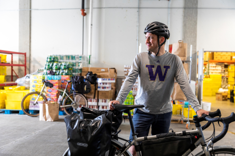 Dan McCabe standing next to a bike inside of a food bank