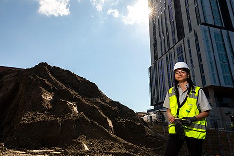 Nancy Le standing in front of a construction site in U District 