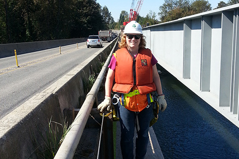 Alumna Amy Leland standing on the former Snohomish River bridge