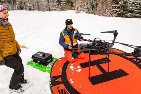 RAPID researcher Andrew Lyra prepares a drone equipped with a lidar instrument.