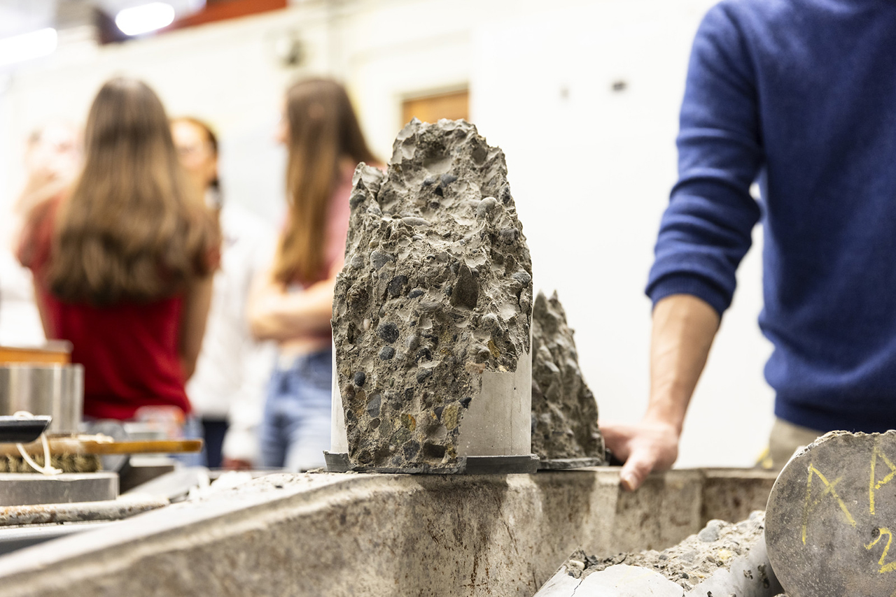 Concrete cores on a surface with people in the background
