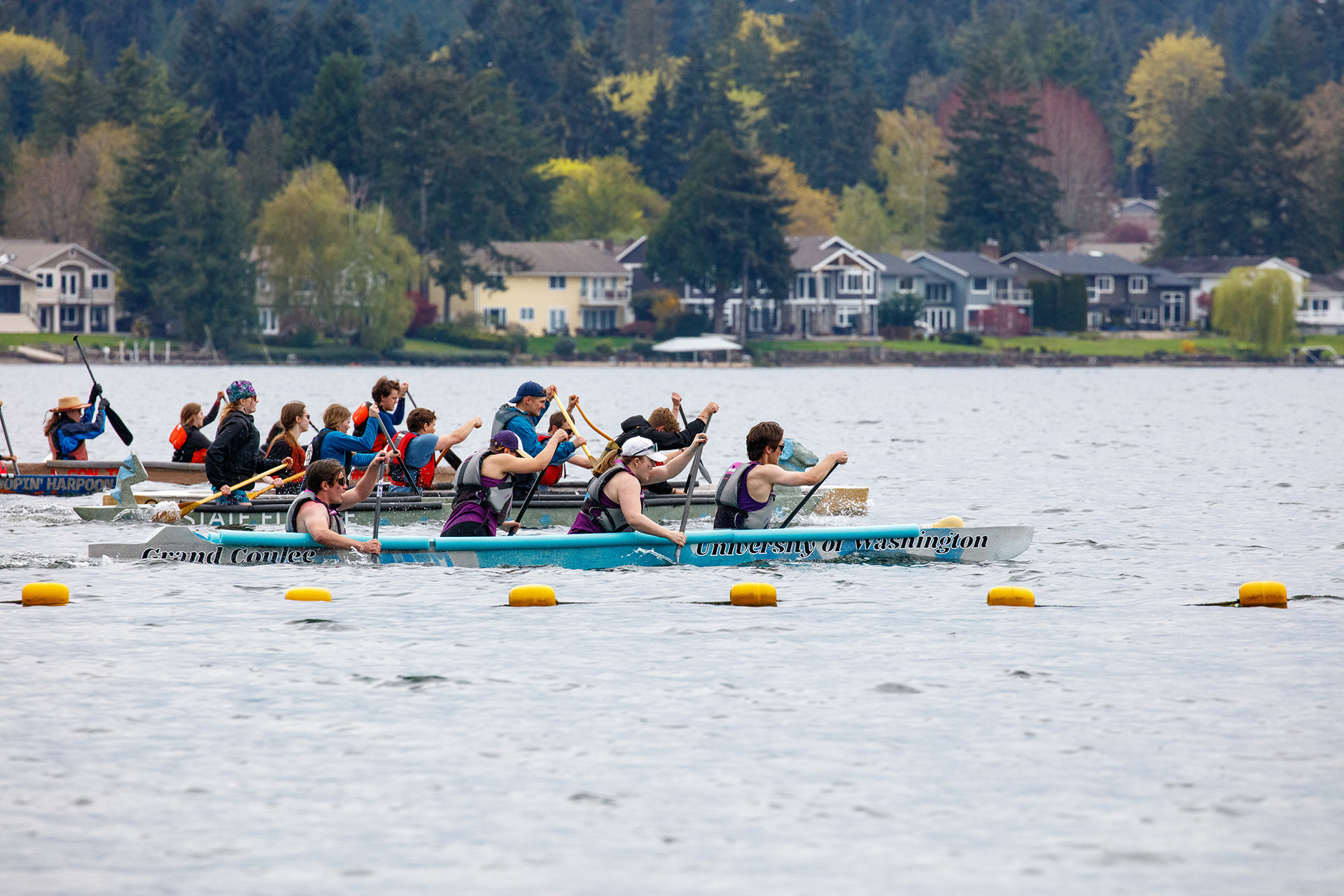 A canoe race with participants paddling on a lake
