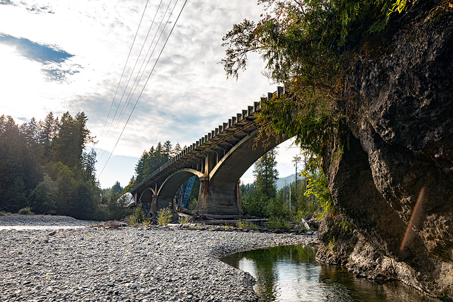 A concrete bridge going over the Elwha River.