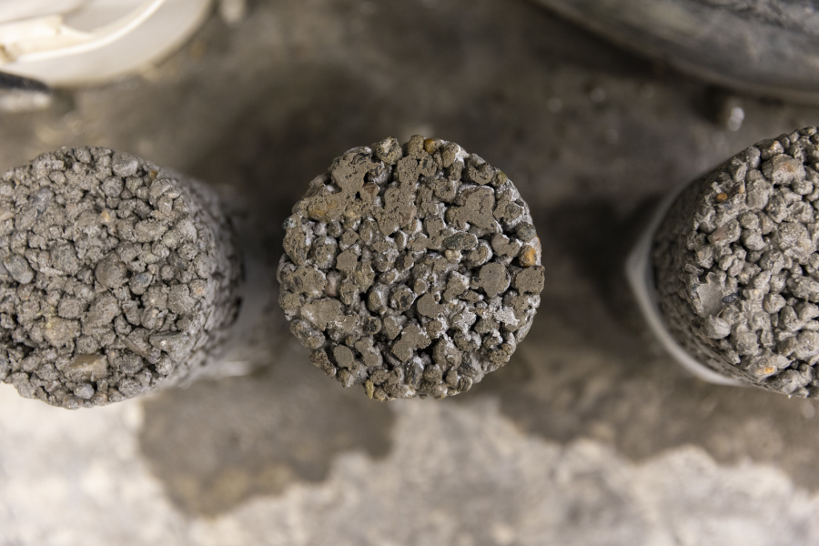 Top view of three concrete test cylinders with rough, textured surfaces