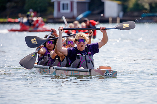 Concrete Canoe team members raise their paddles in celebration after winning the Pacific Northwest ASCE Student Symposium.