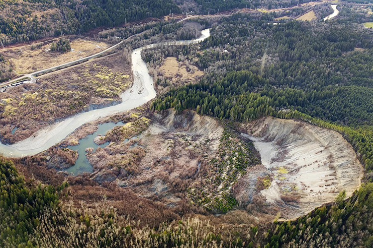 Aerial view of the Oso landslide site showing the massive hillside collapse and debris field.