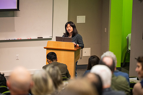 Pei-Hsin Wang presents at a podium to a seated audience at the CoMotion Innovator Showcase.