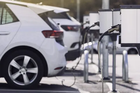 Cars charging at a public EV station